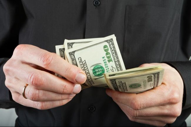 man-counts-money-hands-dollar-usa_186380-760.jpg